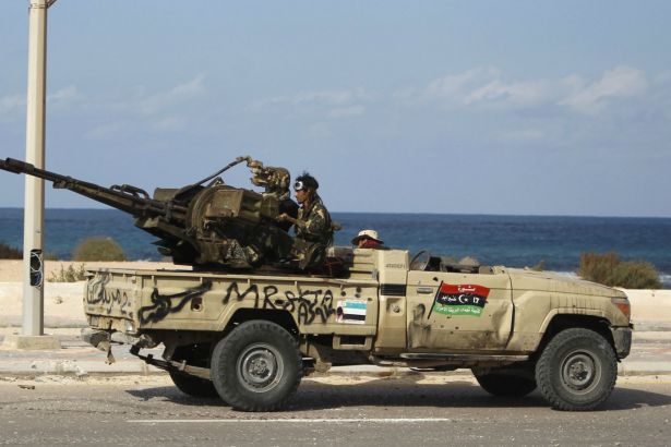 anti-gaddafi-fighters-fire-an-anti-aircraft-heavy-machine-gun-mounted-on-the-back-of-a-pickup-truck-in-2011.jpg